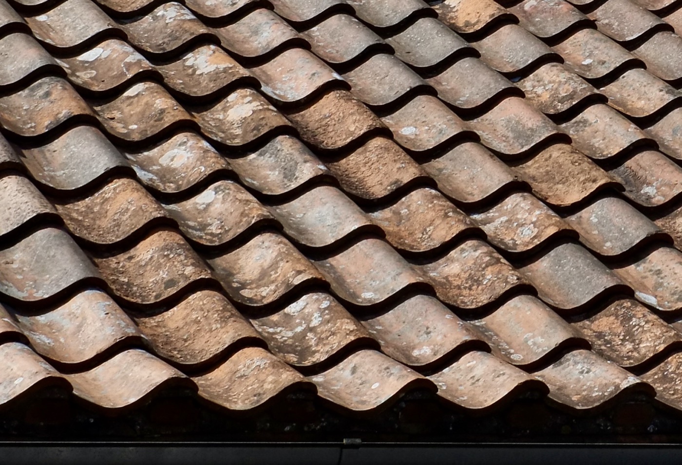 Overlapping roof tiles in warm sunlight
